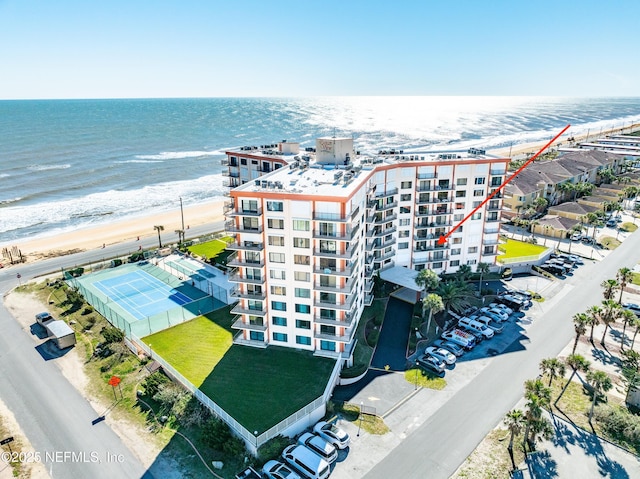 birds eye view of property featuring a water view and a beach view