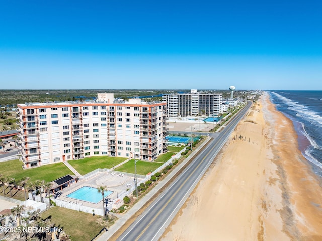 bird's eye view with a water view and a beach view