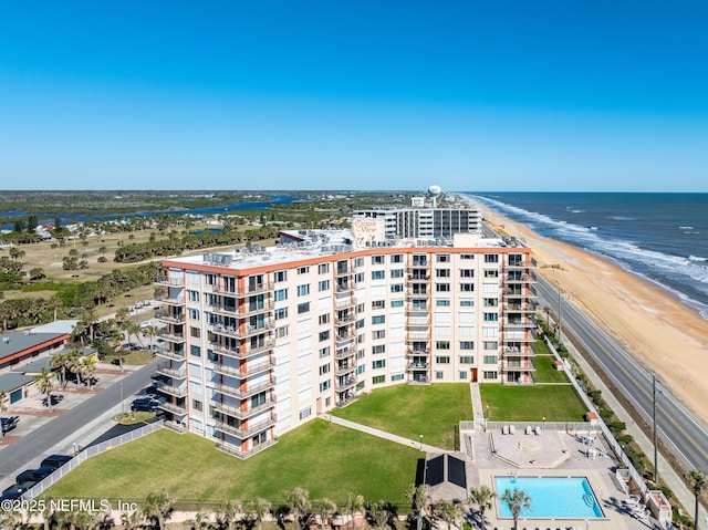 drone / aerial view featuring a view of the beach and a water view