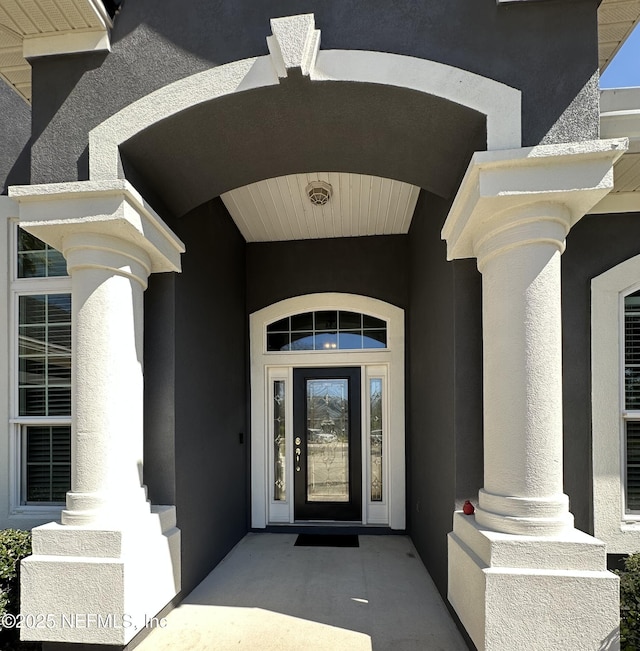 doorway to property with stucco siding