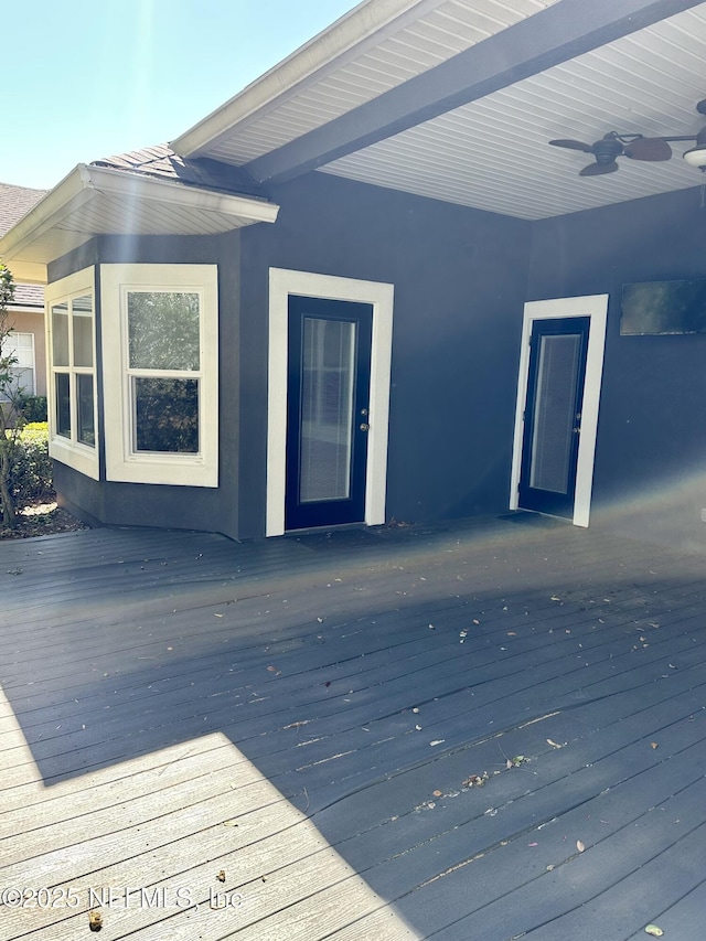 wooden deck with a ceiling fan