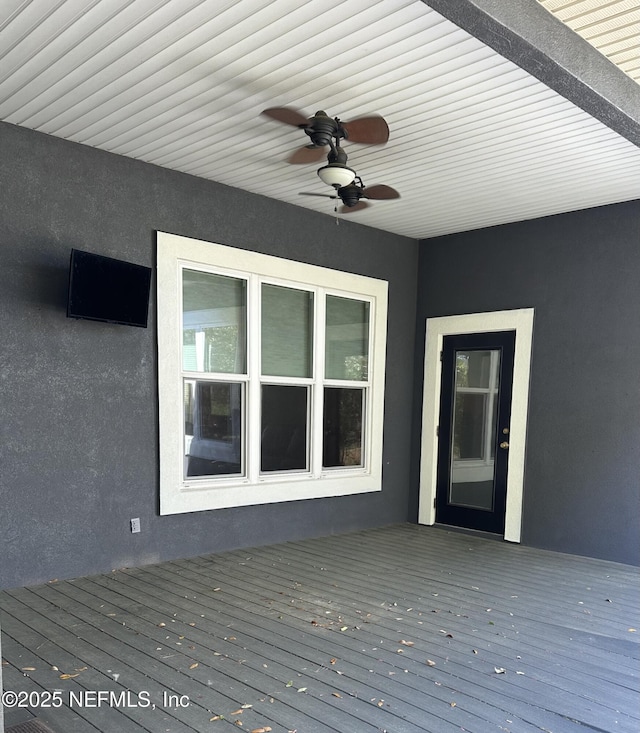 wooden terrace featuring a ceiling fan