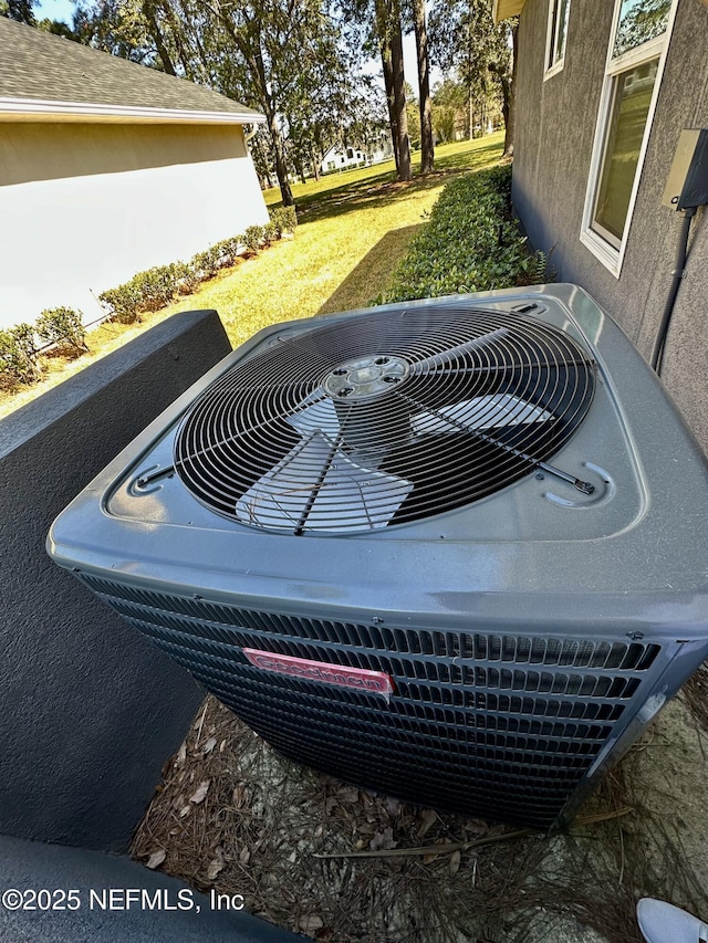 exterior details with central AC and stucco siding