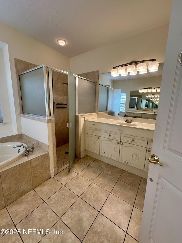 bathroom featuring tile patterned flooring, a shower stall, vanity, and a bath