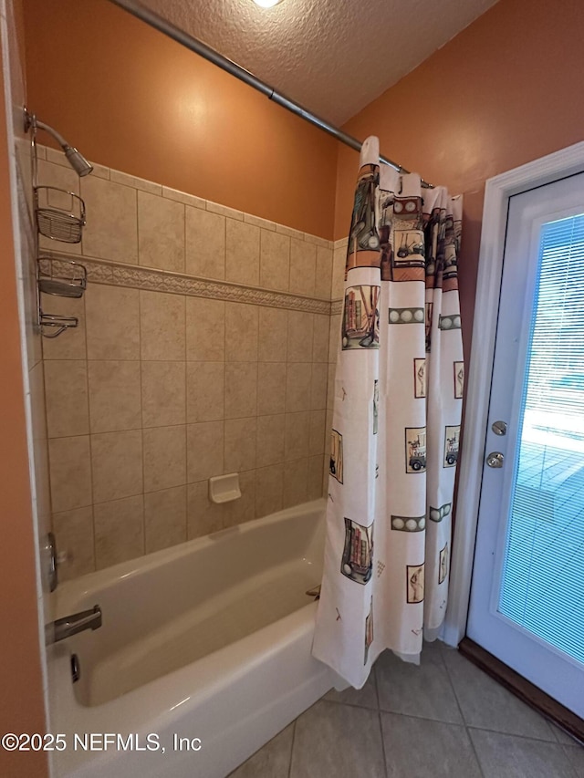 full bath featuring tile patterned flooring, a textured ceiling, and shower / tub combo with curtain