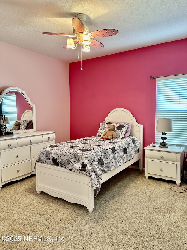 bedroom featuring ceiling fan and a textured ceiling