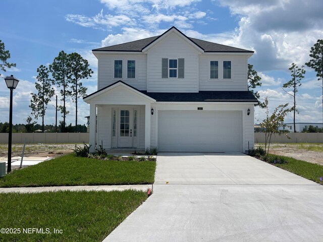 36 Aspendale Rd, Ponte Vedra, FL 32081 - view of front of house with a garage, driveway, and a shingled roof