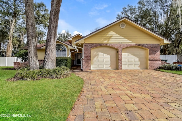 ranch-style house with decorative driveway, brick siding, fence, and an attached garage