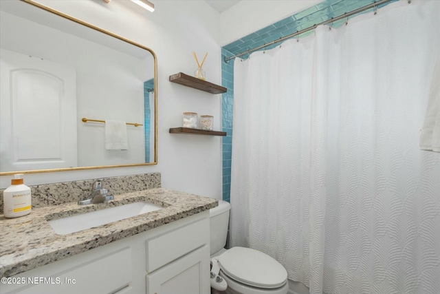 full bath with curtained shower, vanity, and toilet