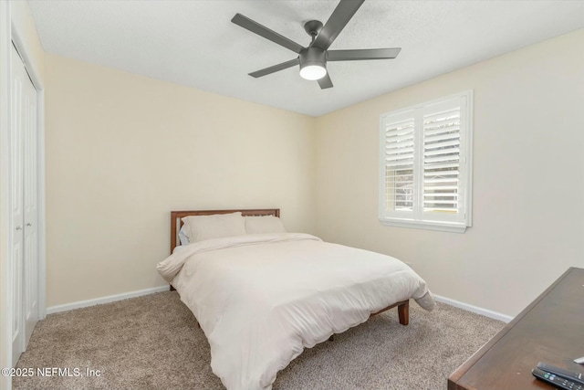 carpeted bedroom with a ceiling fan, baseboards, and a closet