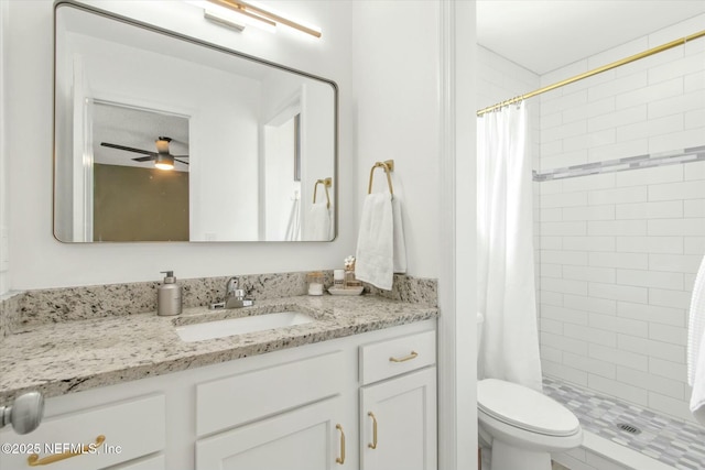 full bathroom featuring toilet, a shower stall, vanity, and a ceiling fan