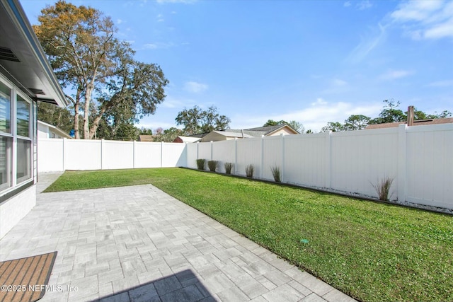 view of yard with a fenced backyard and a patio