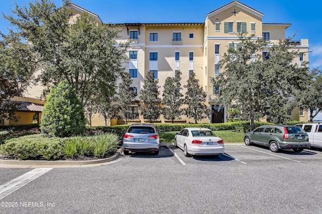 view of property featuring uncovered parking