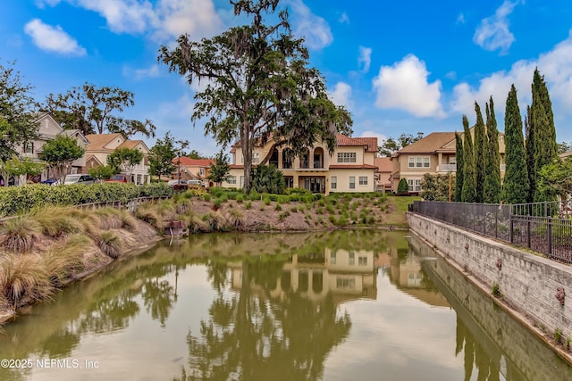 water view featuring fence and a residential view