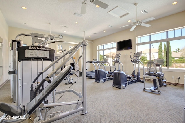 gym with a ceiling fan, recessed lighting, visible vents, and a textured ceiling