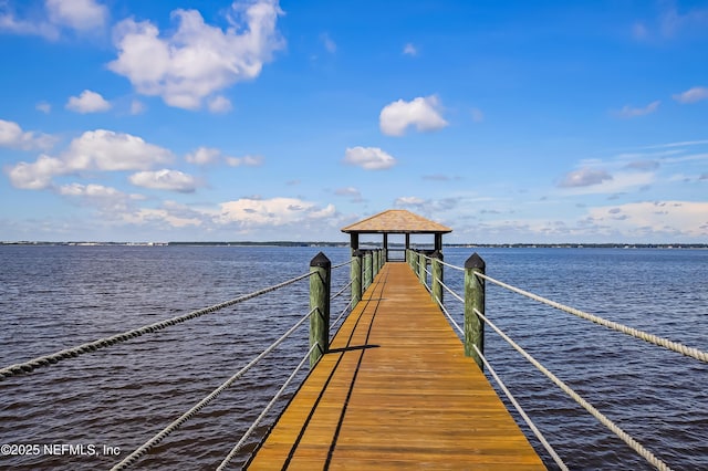 view of dock with a water view and a gazebo