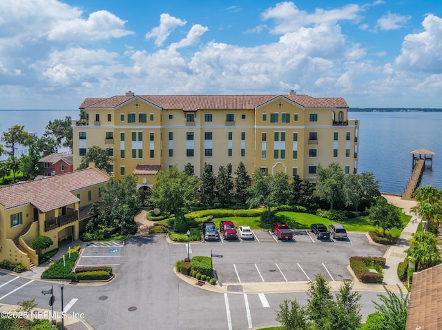 view of property featuring uncovered parking and a water view