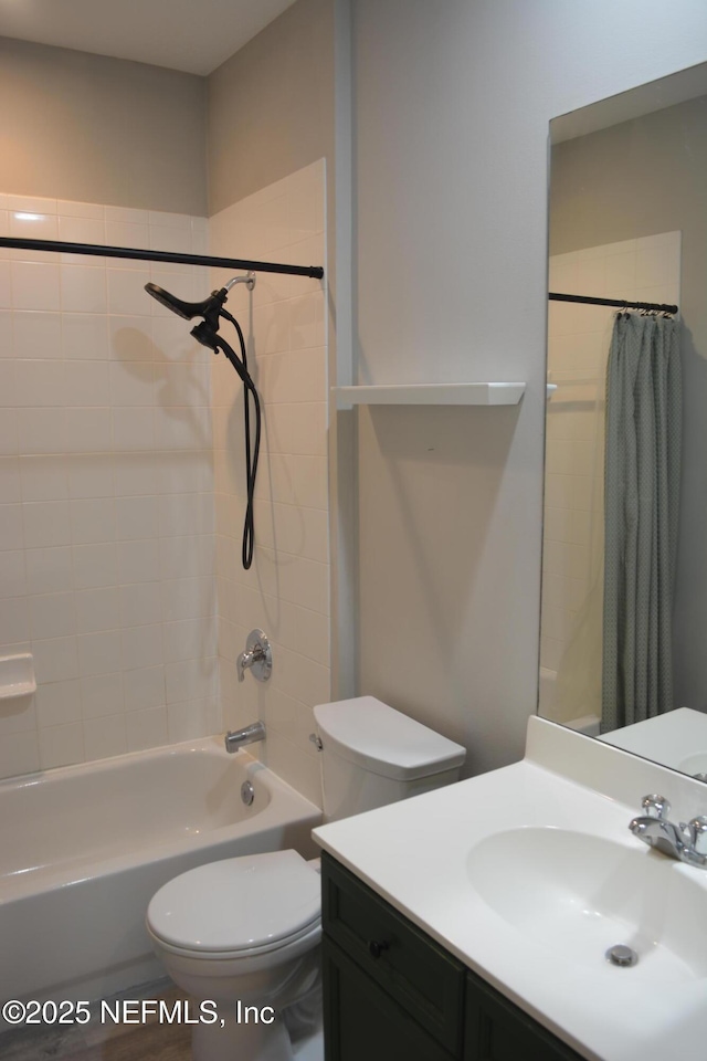 bathroom with vanity, shower / bath combo with shower curtain, and toilet