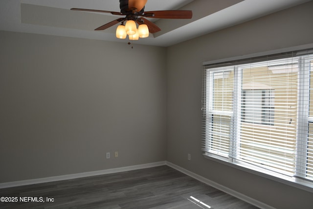 spare room featuring ceiling fan, wood finished floors, and baseboards