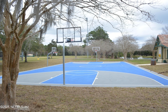 view of sport court featuring community basketball court and a lawn