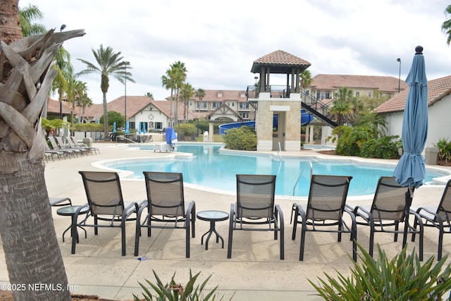 community pool with a patio area