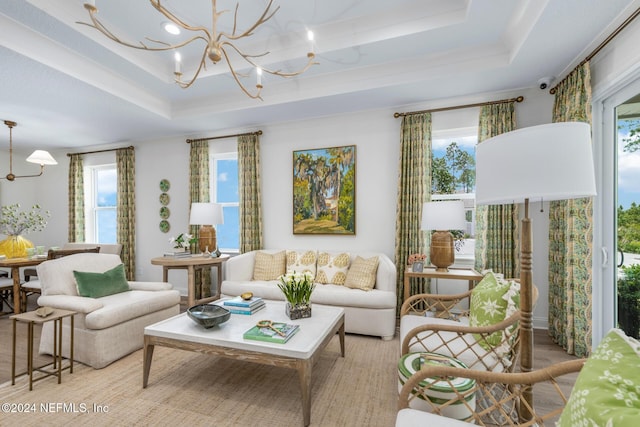 living area featuring a chandelier, wood finished floors, and a raised ceiling