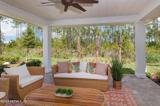 sunroom featuring a healthy amount of sunlight, wooden ceiling, and ceiling fan