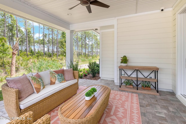 sunroom featuring ceiling fan