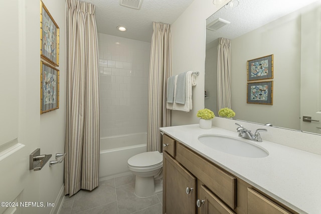 bathroom featuring visible vents, a textured ceiling, toilet, and tile patterned floors