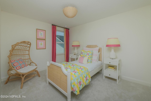 bedroom featuring carpet and baseboards