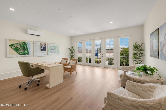 office with a wall unit AC, light wood finished floors, baseboards, and recessed lighting