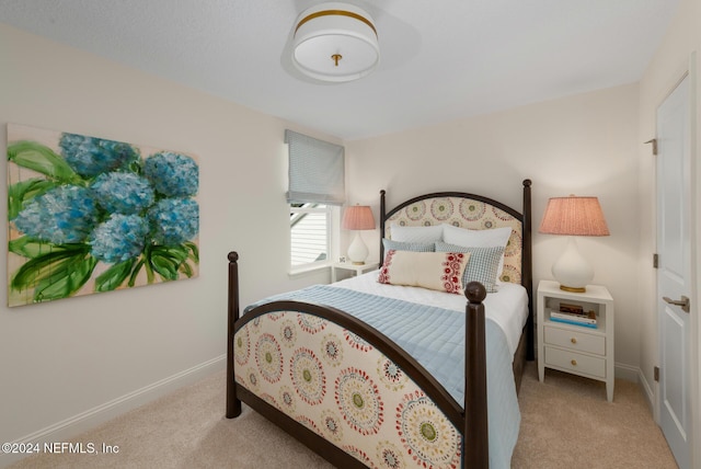 carpeted bedroom with baseboards