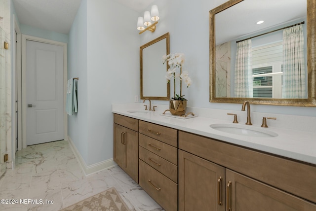 full bathroom with marble finish floor, double vanity, a sink, and baseboards