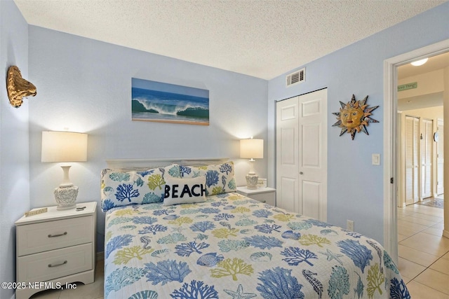 110 Ocean Hollow Ln Unit 116, Saint Augustine, FL 32084 - bedroom with light tile patterned floors, a textured ceiling, visible vents, and a closet