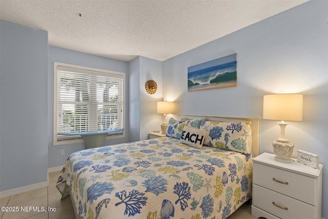 110 Ocean Hollow Ln Unit 116, Saint Augustine, FL 32084 - bedroom featuring a textured ceiling, tile patterned flooring, and baseboards