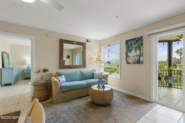 sitting room with ceiling fan, visible vents, baseboards, and light tile patterned flooring