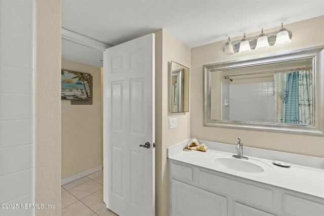 110 Ocean Hollow Ln Unit 116, Saint Augustine, FL 32084 - full bathroom featuring a shower with shower curtain, vanity, baseboards, and tile patterned floors