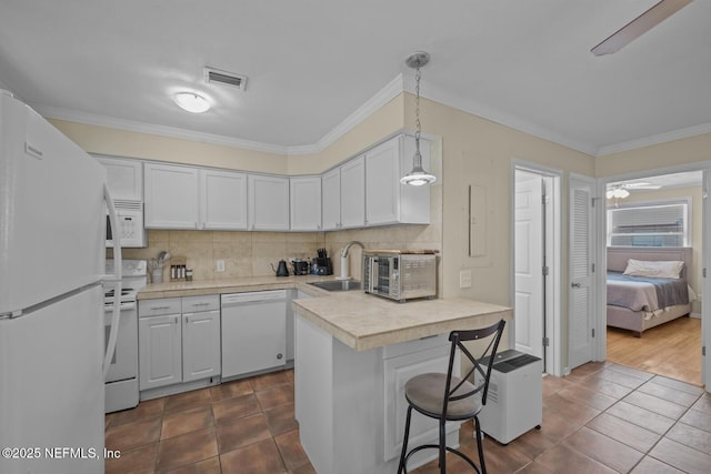 2107 2nd St S, Jacksonville Beach, FL 32250 - kitchen with tasteful backsplash, white appliances, ceiling fan, and a sink