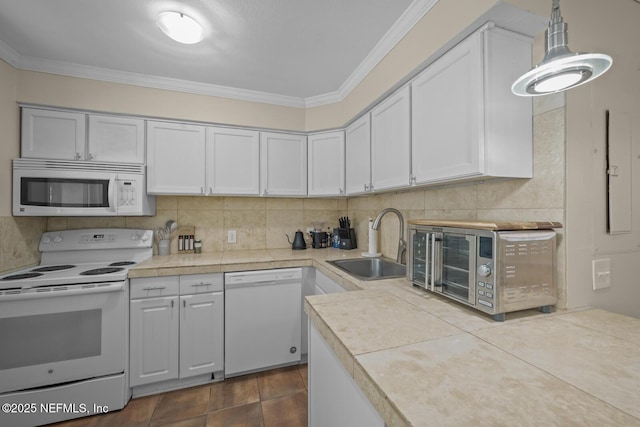 2107 2nd St S, Jacksonville Beach, FL 32250 - kitchen featuring white appliances, crown molding, backsplash, and a sink
