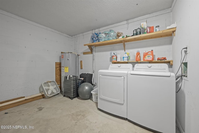 2107 2nd St S, Jacksonville Beach, FL 32250 - clothes washing area with concrete block wall, washing machine and clothes dryer, laundry area, a textured ceiling, and electric water heater