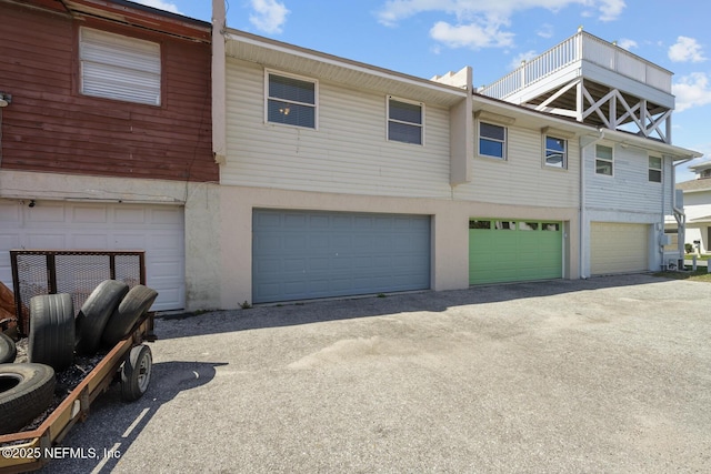 2107 2nd St S, Jacksonville Beach, FL 32250 - townhome / multi-family property with aphalt driveway, stucco siding, and a garage