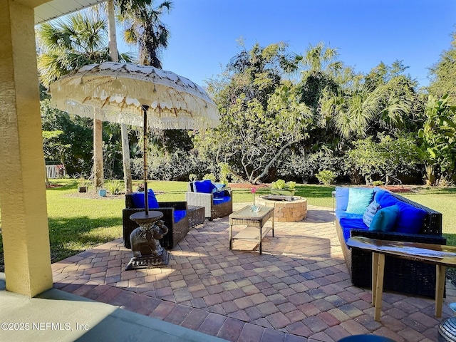 view of patio / terrace with an outdoor living space with a fire pit