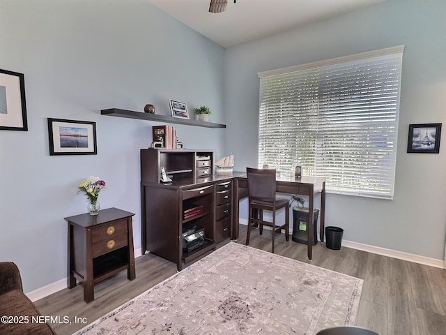 home office featuring a ceiling fan, baseboards, and wood finished floors