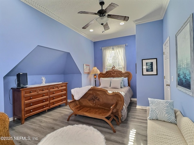 bedroom with ornamental molding, ceiling fan, baseboards, and wood finished floors