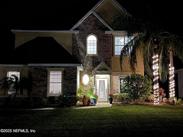 traditional-style house featuring a yard