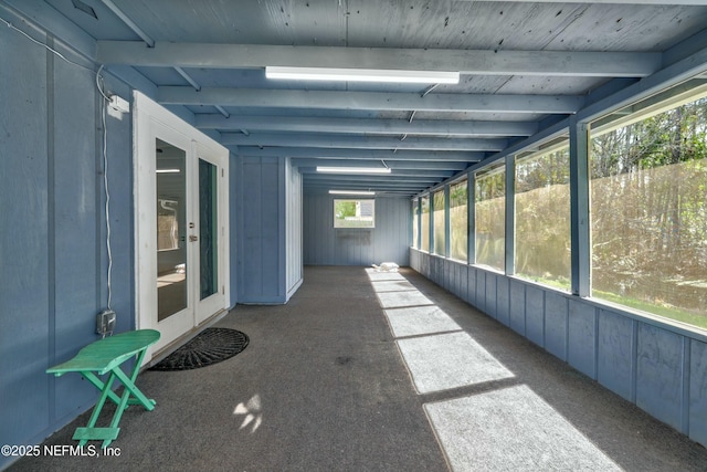 unfurnished sunroom with beam ceiling