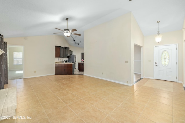 unfurnished living room with high vaulted ceiling, light tile patterned flooring, ceiling fan, and baseboards