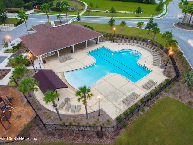 community pool featuring fence and a patio area