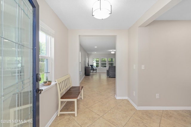 foyer with baseboards and light tile patterned floors