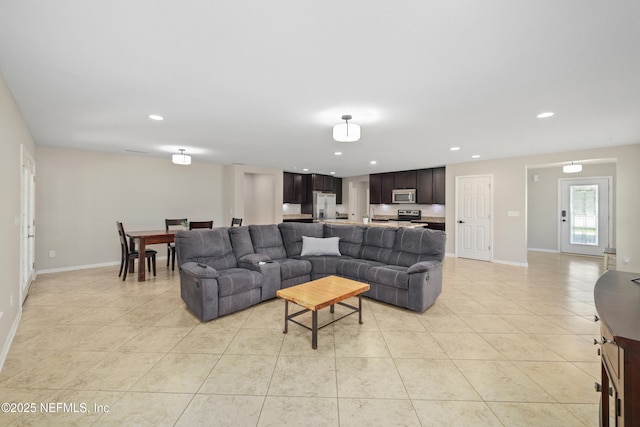 living room with recessed lighting, baseboards, and light tile patterned floors